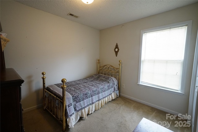 bedroom with carpet and a textured ceiling