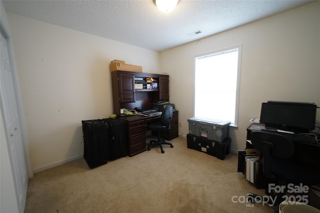 office area with light colored carpet and a textured ceiling