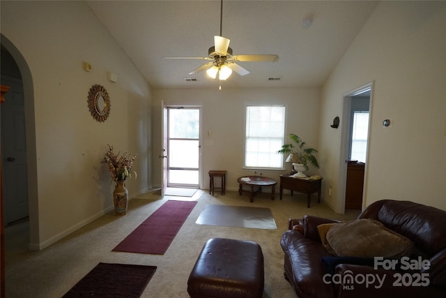 carpeted living room featuring ceiling fan and lofted ceiling