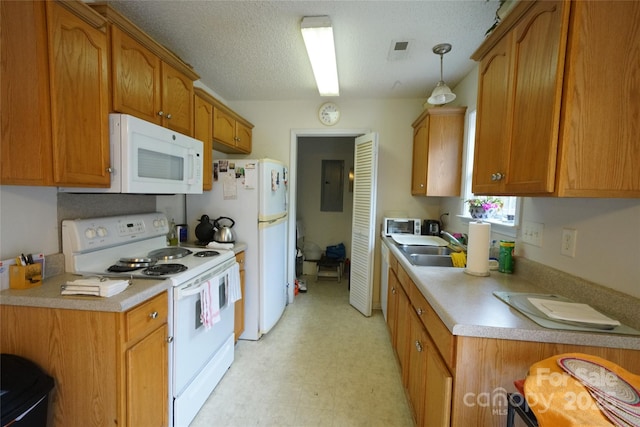 kitchen with sink, white appliances, a textured ceiling, and hanging light fixtures