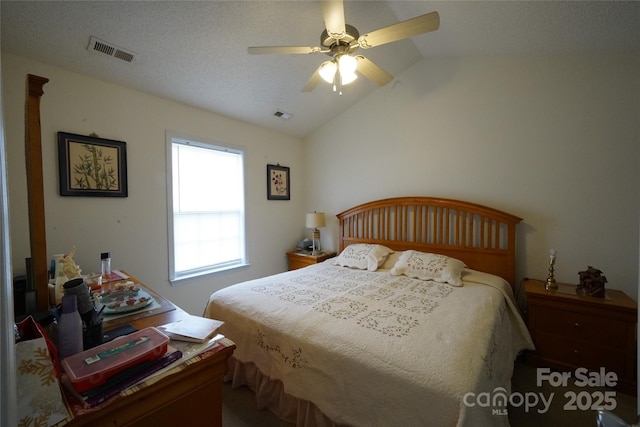 bedroom with ceiling fan, a textured ceiling, and lofted ceiling