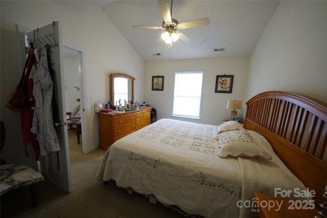 bedroom featuring vaulted ceiling, ceiling fan, and light colored carpet