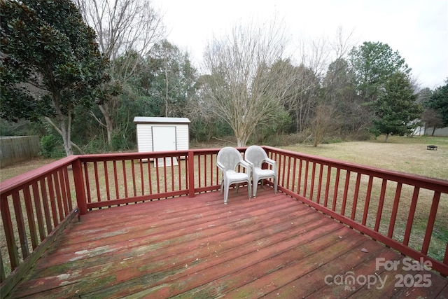 wooden deck with a shed and a yard