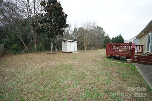 view of yard with a deck and a storage unit