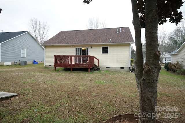 back of property featuring central AC, a wooden deck, and a yard