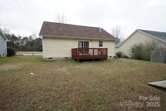 back of house with a wooden deck and a lawn