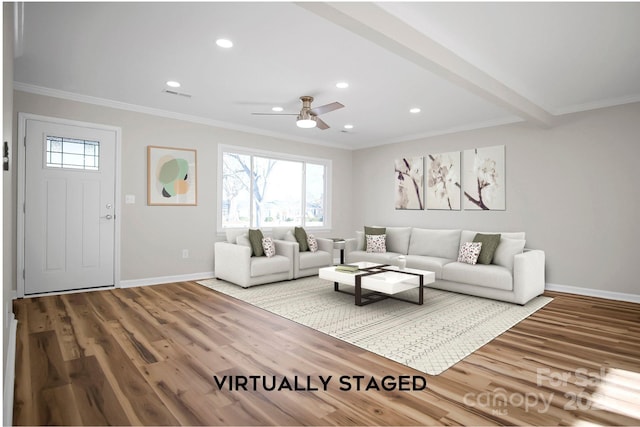 living room with ceiling fan, beam ceiling, wood-type flooring, and ornamental molding