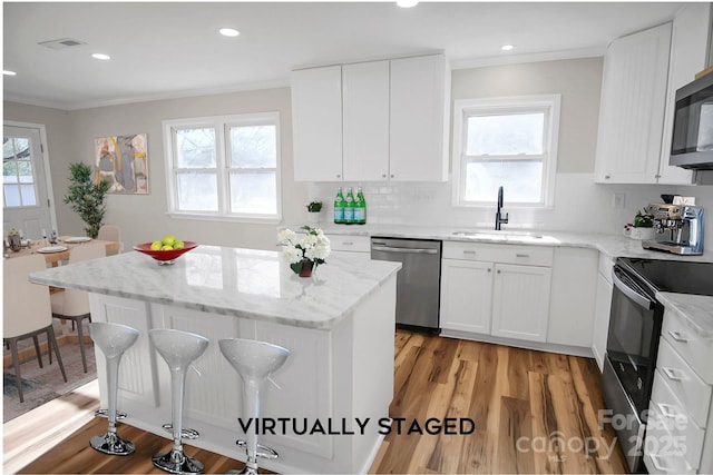 kitchen featuring dishwasher, black range with electric cooktop, white cabinets, and sink