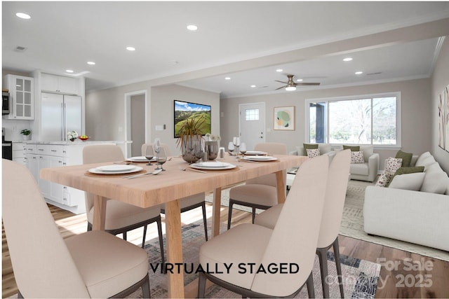 dining space with ceiling fan, light hardwood / wood-style floors, and ornamental molding