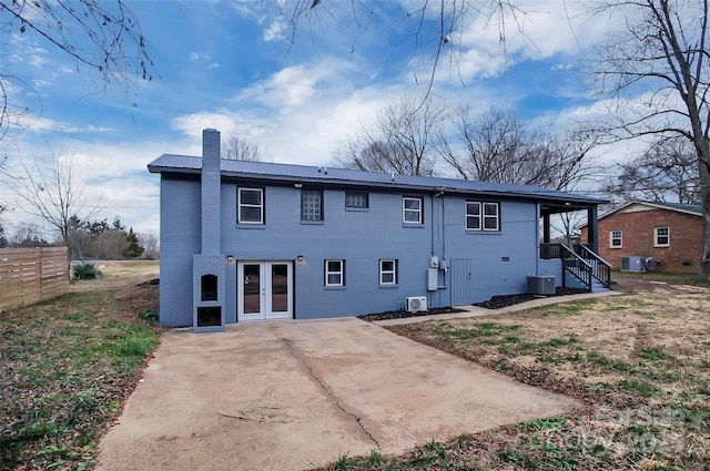 rear view of house with cooling unit and a patio