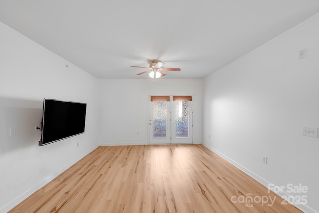 unfurnished living room featuring ceiling fan, light hardwood / wood-style floors, and french doors