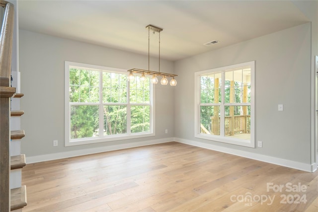 unfurnished dining area featuring light hardwood / wood-style floors