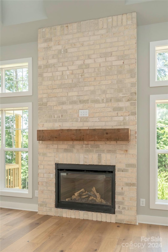 room details featuring hardwood / wood-style floors and a brick fireplace