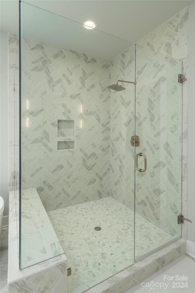 bathroom featuring a shower with door