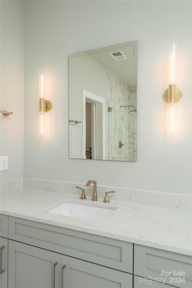 bathroom featuring vanity and a tile shower