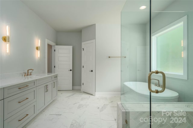 bathroom featuring vanity and tiled tub