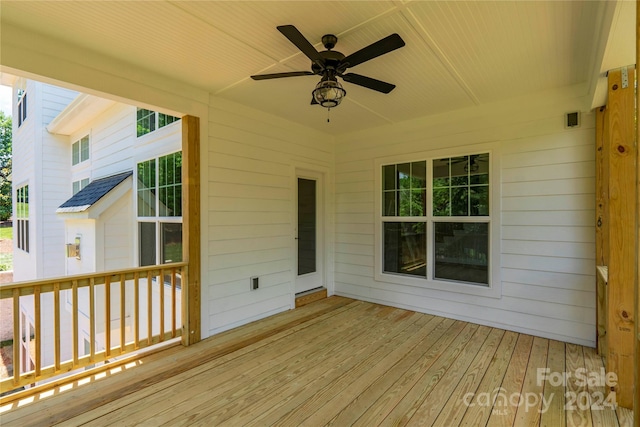 wooden deck featuring ceiling fan