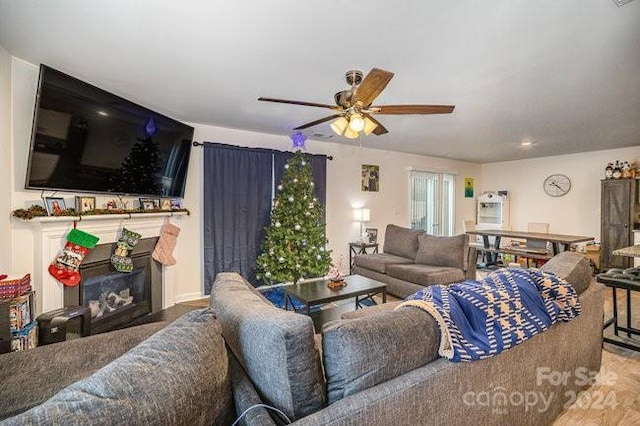 living room with wood-type flooring and ceiling fan