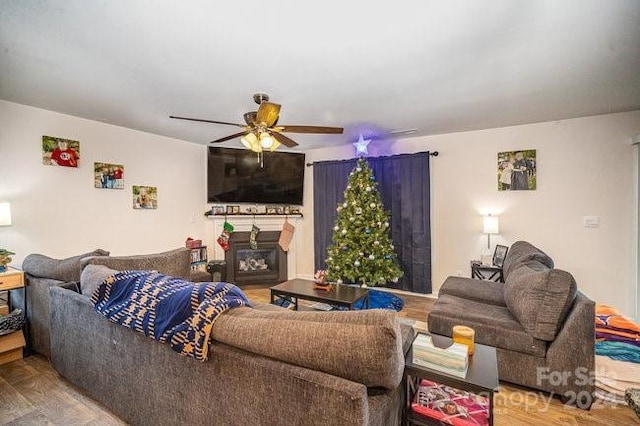 living room featuring hardwood / wood-style flooring and ceiling fan