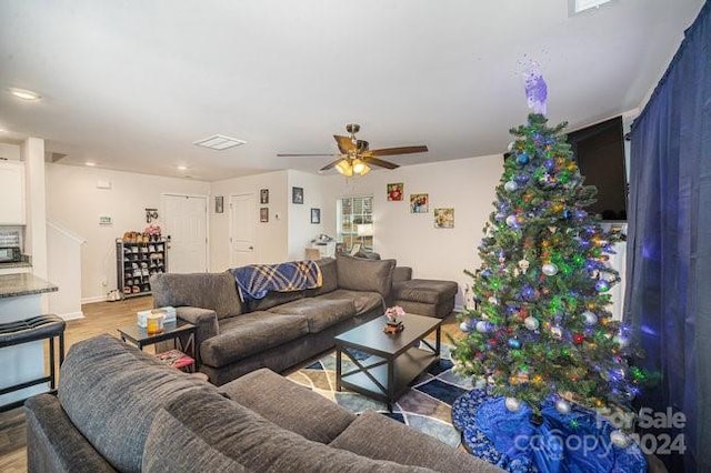 living room featuring light wood-type flooring and ceiling fan