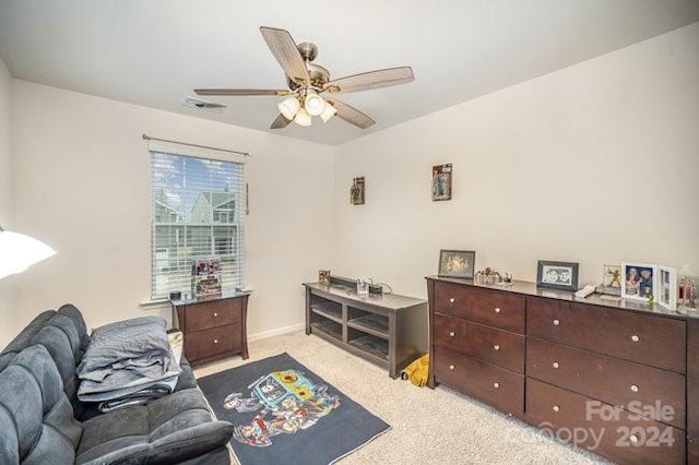 interior space with ceiling fan and light colored carpet