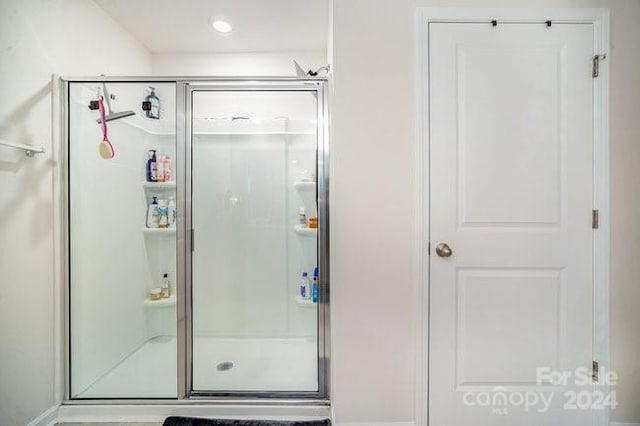 bathroom with a shower with shower door