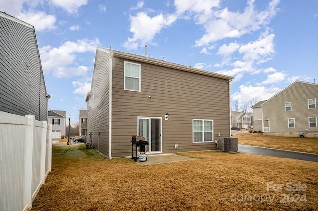 rear view of house featuring cooling unit