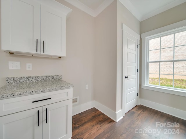 bar with light stone counters, white cabinetry, dark wood-type flooring, and ornamental molding