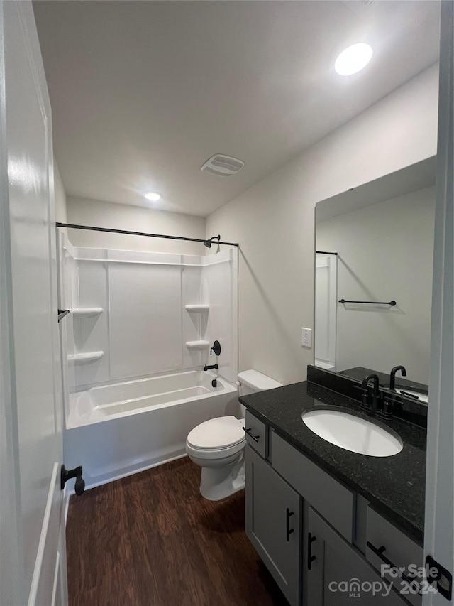 full bathroom featuring bathing tub / shower combination, vanity, wood-type flooring, and toilet