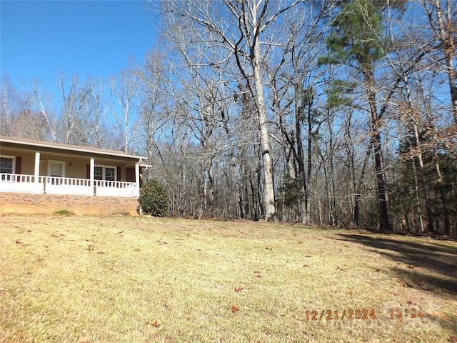 view of yard featuring covered porch