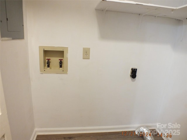 clothes washing area with washer hookup, hookup for an electric dryer, laundry area, electric panel, and baseboards