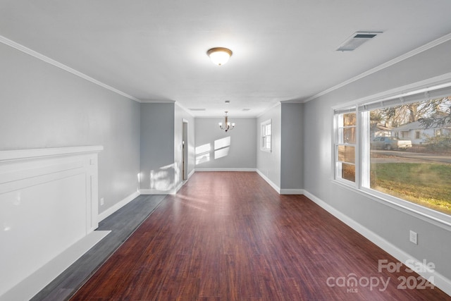 unfurnished living room with ornamental molding, dark wood-type flooring, and an inviting chandelier