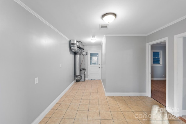 interior space with crown molding and light tile patterned flooring