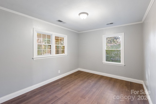 spare room with wood-type flooring and crown molding