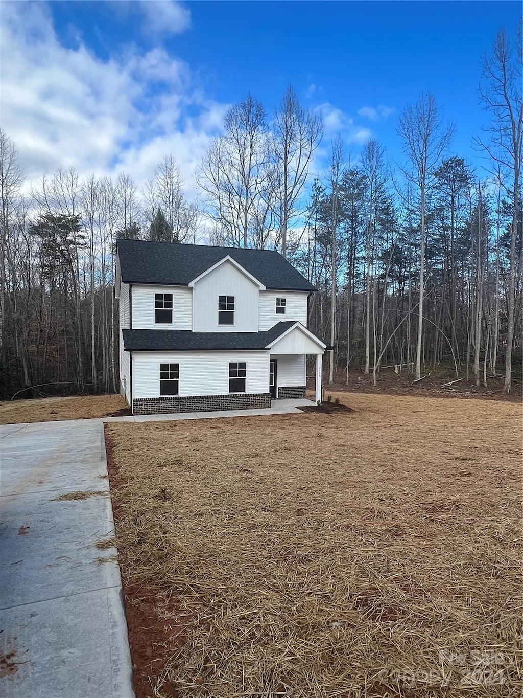 view of property exterior with a lawn and a patio