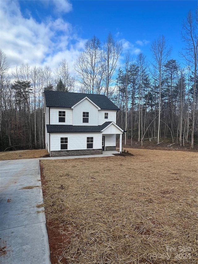 view of property exterior with a lawn and a patio