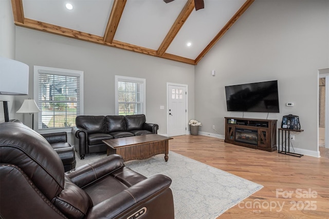 living room featuring beamed ceiling, high vaulted ceiling, and hardwood / wood-style floors