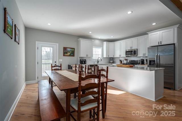 dining space with light hardwood / wood-style flooring