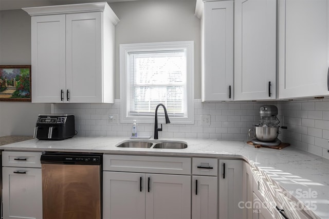 kitchen with dishwasher, decorative backsplash, white cabinetry, and sink