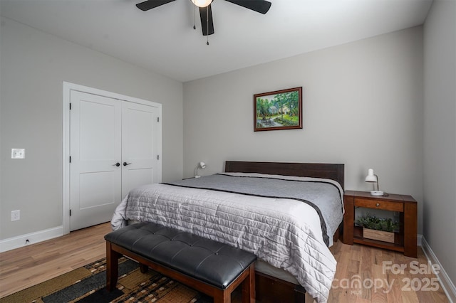 bedroom with ceiling fan, light hardwood / wood-style flooring, and a closet