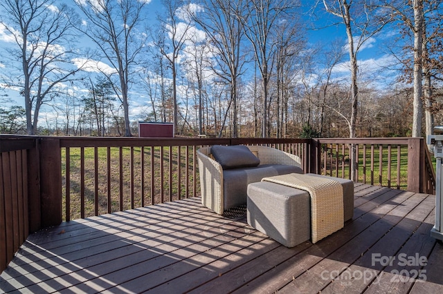 wooden terrace featuring a storage shed