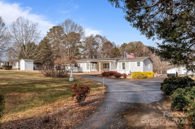 ranch-style house with a porch and a front lawn