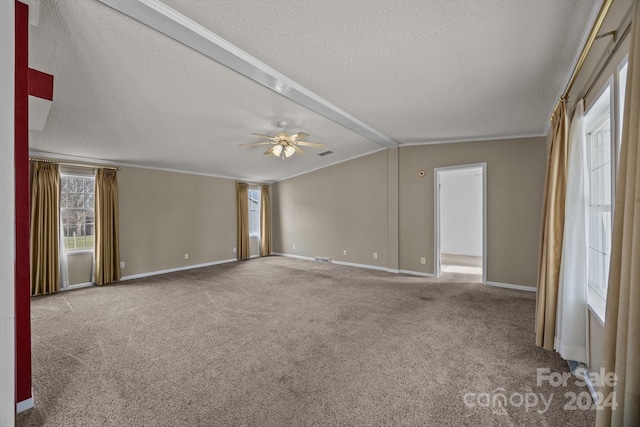 carpeted empty room featuring vaulted ceiling with beams, ceiling fan, a textured ceiling, and ornamental molding