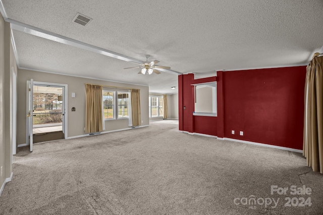 unfurnished living room featuring ceiling fan, carpet floors, and a textured ceiling