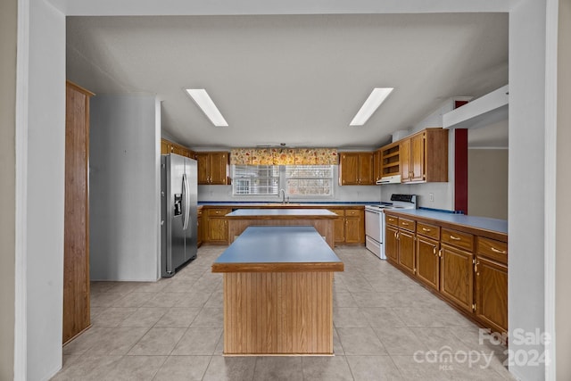 kitchen featuring a center island, sink, stainless steel fridge with ice dispenser, white range with electric cooktop, and exhaust hood