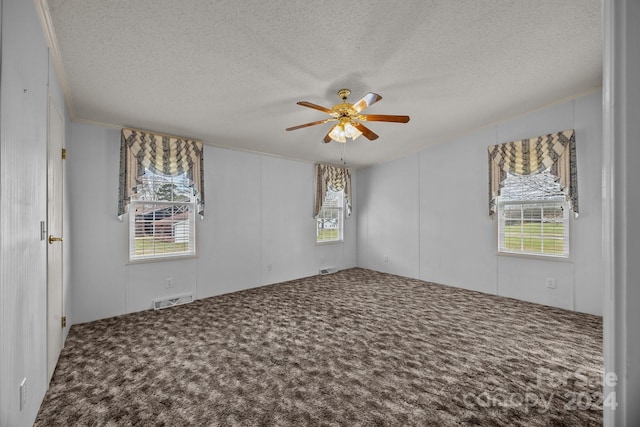 spare room with ceiling fan, crown molding, carpet floors, and a textured ceiling