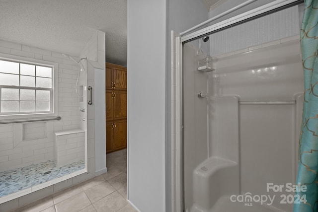 bathroom featuring tile patterned floors, a textured ceiling, and walk in shower