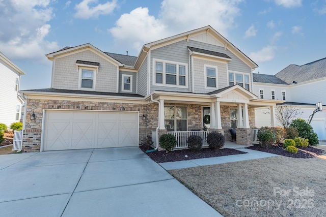 craftsman inspired home featuring covered porch and a garage