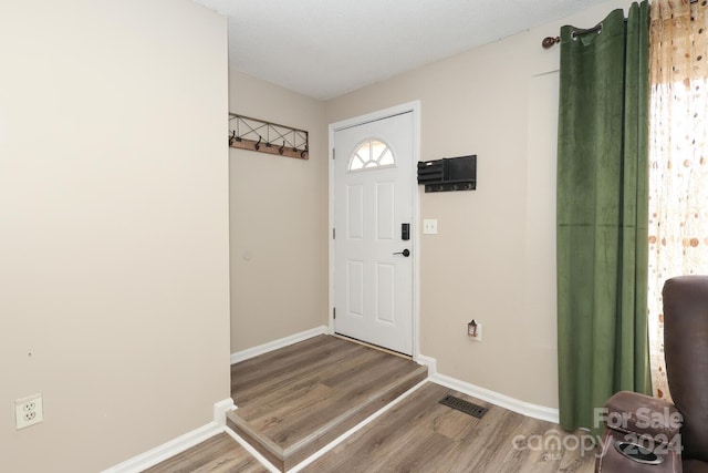 entrance foyer featuring a textured ceiling and hardwood / wood-style flooring