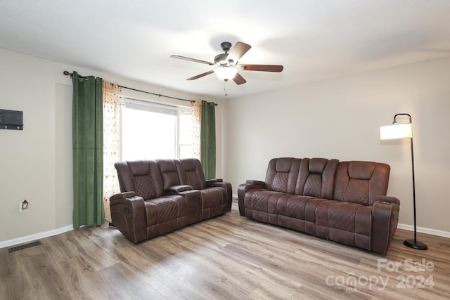 living room featuring light wood-type flooring and ceiling fan